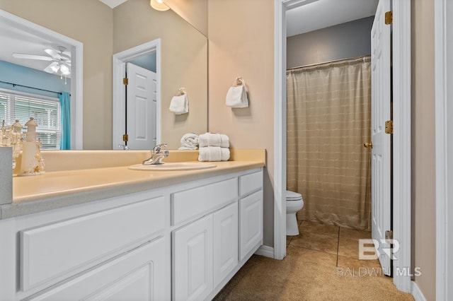 bathroom featuring ceiling fan, curtained shower, tile patterned floors, toilet, and vanity