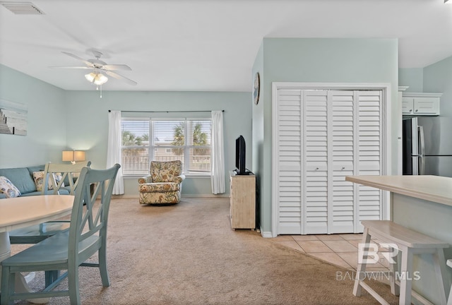 interior space featuring light carpet and ceiling fan