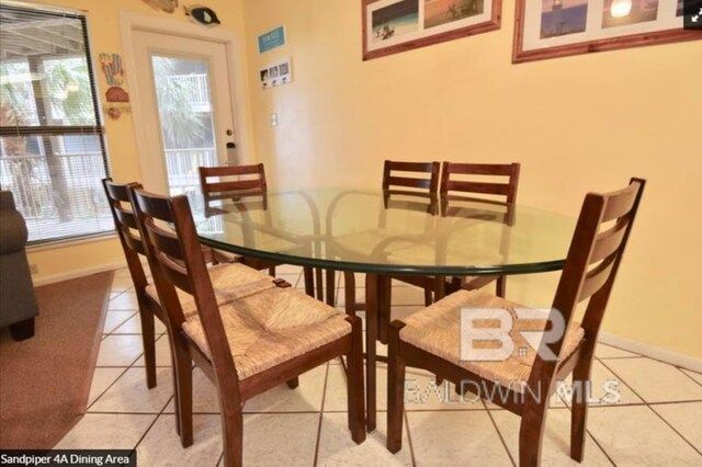 1069 W Beach Blvd Unit 4-A, Gulf Shores, AL 36542 - dining space with healthy amount of natural light and light tile patterned floors