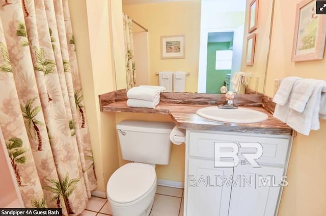 bathroom with tile patterned flooring, vanity, a shower with shower curtain, and toilet