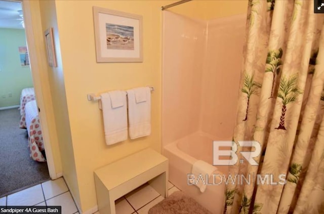 bathroom with tile patterned floors and shower / bath combo with shower curtain