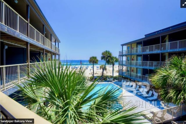 view of pool with a water view and a view of the beach