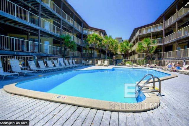 1069 W Beach Blvd Unit 4-A, Gulf Shores, AL 36542 - community pool featuring a wooden deck