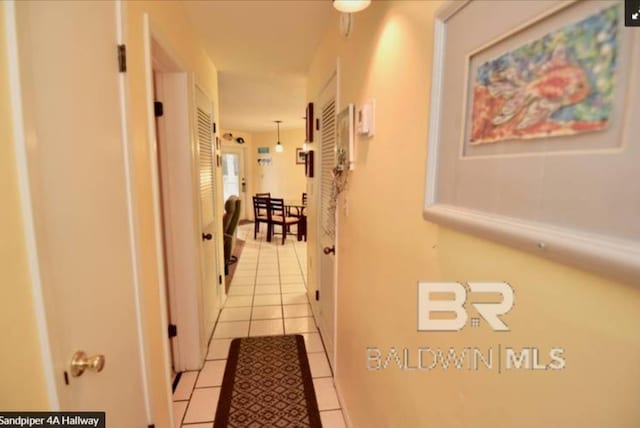 hall featuring light tile patterned flooring