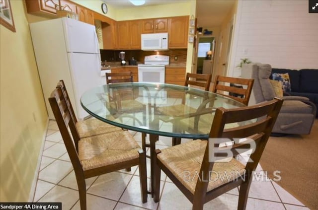 dining space with light tile patterned floors