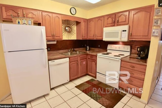 1069 W Beach Blvd Unit 4-A, Gulf Shores, AL 36542 - kitchen featuring white appliances, backsplash, and light tile patterned floors