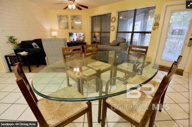 dining space with ceiling fan and light tile patterned floors