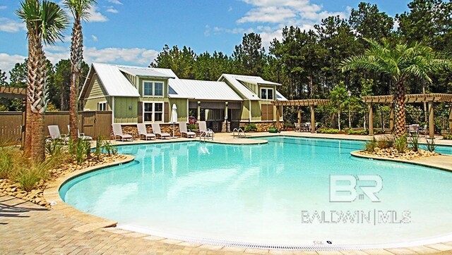 view of swimming pool with a pergola