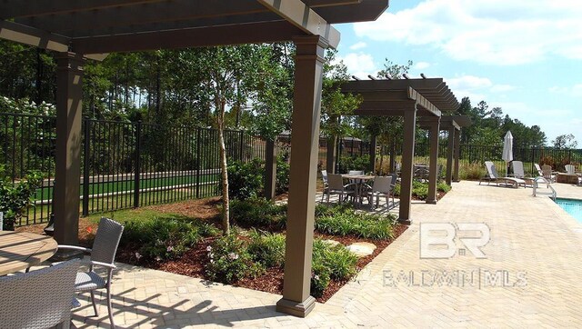 view of patio / terrace featuring a pergola and a fenced in pool