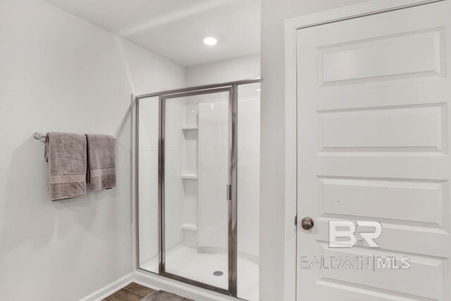 bathroom with a shower with shower door