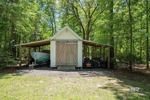 view of outbuilding featuring a carport and an outbuilding