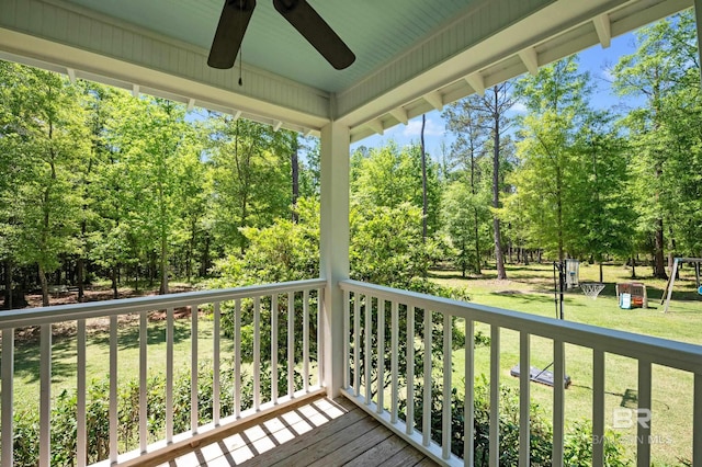 deck with a yard and a ceiling fan