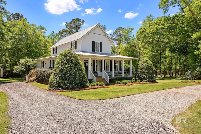 farmhouse inspired home with a porch, a front lawn, and metal roof