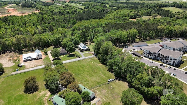 birds eye view of property featuring a forest view