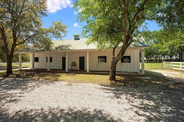 view of front of house with board and batten siding and fence