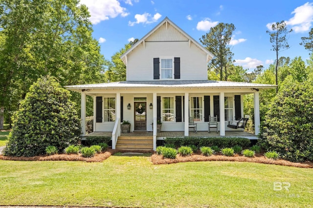 farmhouse inspired home featuring a front yard, a porch, and metal roof