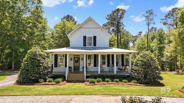 farmhouse inspired home featuring a front yard, a porch, and metal roof