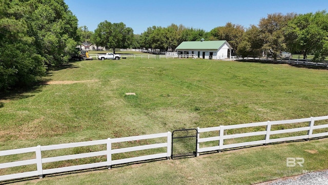 view of yard featuring a rural view and fence