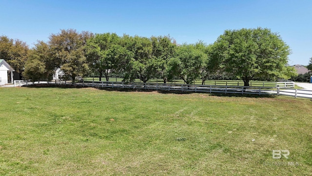 view of yard featuring fence and a rural view
