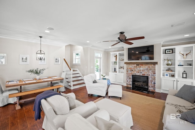 living room with stairs, dark wood-style floors, and crown molding