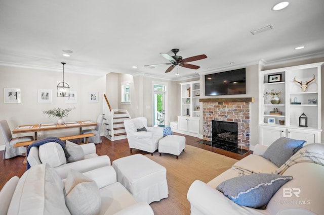 living area featuring a ceiling fan, ornamental molding, and dark wood-style floors