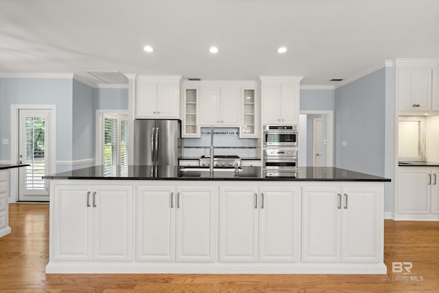kitchen with white cabinetry, dark countertops, and appliances with stainless steel finishes