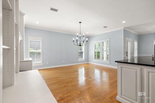 unfurnished dining area featuring a chandelier, visible vents, light wood-style flooring, and recessed lighting