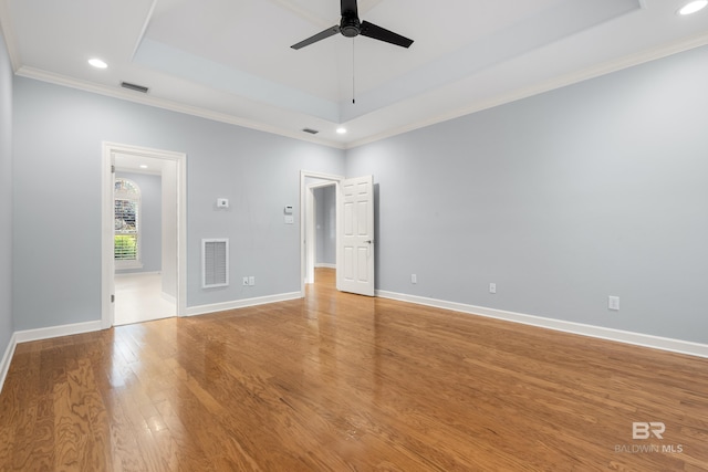30595 Laurel Ct, Daphne, AL 36527 - empty room featuring ceiling fan, light wood-style floors, a tray ceiling, visible vents, and ornamental molding