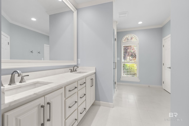 bathroom featuring baseboards, ornamental molding, and a sink