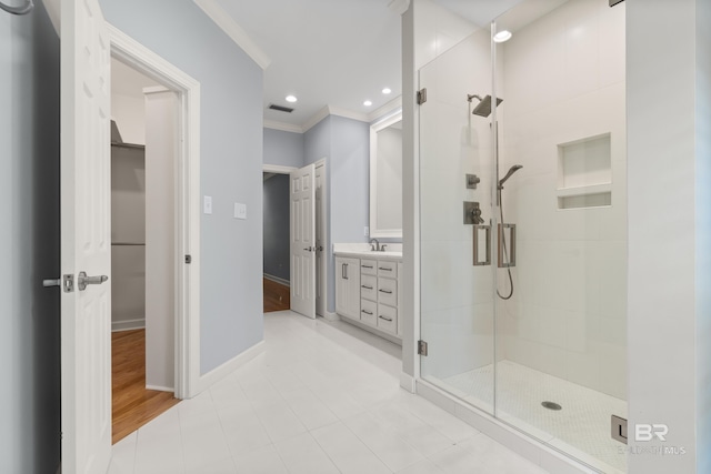 full bath with vanity, baseboards, a shower stall, visible vents, and ornamental molding
