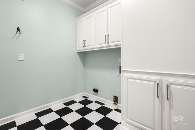washroom featuring cabinet space, tile patterned floors, and ornamental molding