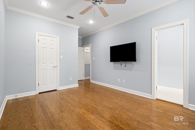 unfurnished living room featuring recessed lighting, ornamental molding, ceiling fan, and wood finished floors