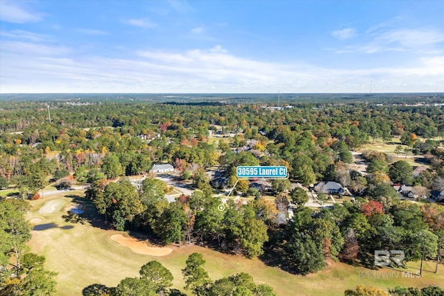drone / aerial view featuring a view of trees and golf course view