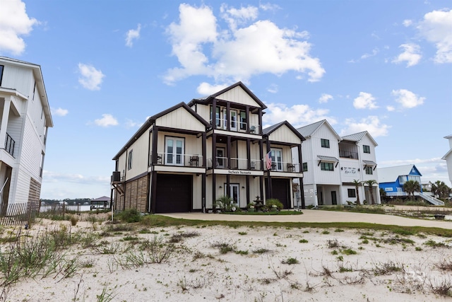 2282 W W Beach Blvd, Gulf Shores, AL 36542 - view of front of house with a balcony, an attached garage, concrete driveway, and a residential view