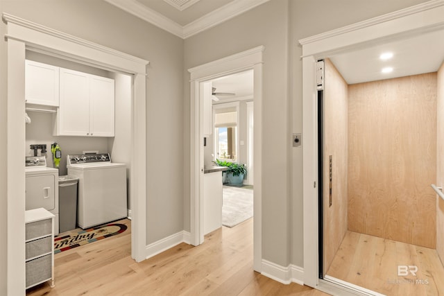 2282 W W Beach Blvd, Gulf Shores, AL 36542 - laundry room with ornamental molding, light wood-style floors, washing machine and dryer, cabinet space, and elevator