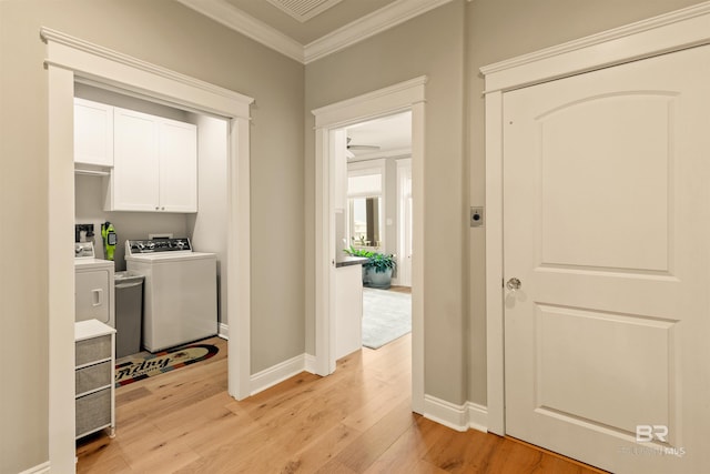 2282 W W Beach Blvd, Gulf Shores, AL 36542 - laundry room with crown molding, light wood finished floors, cabinet space, and washer and clothes dryer