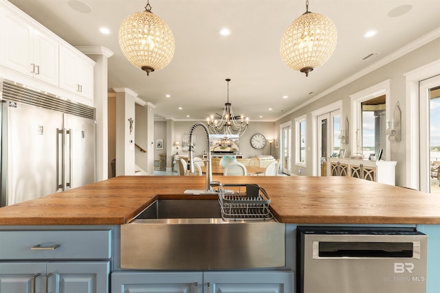 2282 W W Beach Blvd, Gulf Shores, AL 36542 - kitchen with a chandelier, wooden counters, built in fridge, stainless steel dishwasher, and blue cabinetry