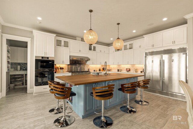 2282 W W Beach Blvd, Gulf Shores, AL 36542 - kitchen featuring stainless steel built in refrigerator, butcher block counters, range hood, white cabinetry, and recessed lighting