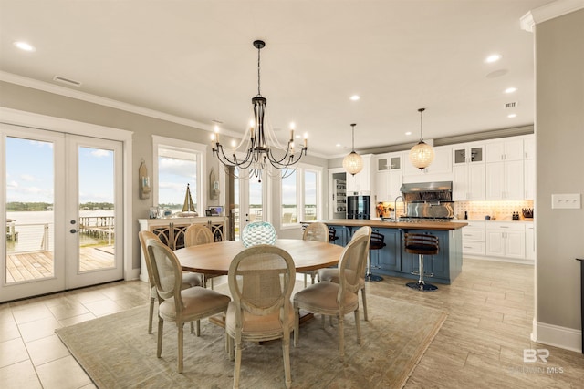 2282 W W Beach Blvd, Gulf Shores, AL 36542 - dining room featuring french doors, crown molding, a chandelier, and recessed lighting