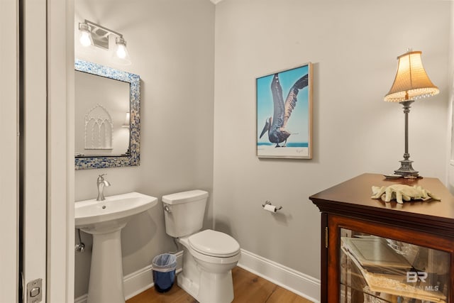 2282 W W Beach Blvd, Gulf Shores, AL 36542 - half bathroom featuring baseboards and wood finished floors