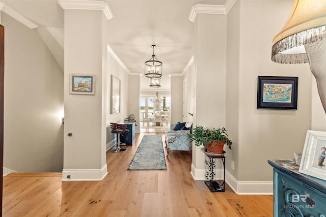 2282 W W Beach Blvd, Gulf Shores, AL 36542 - entryway featuring ornamental molding, a chandelier, and light wood finished floors
