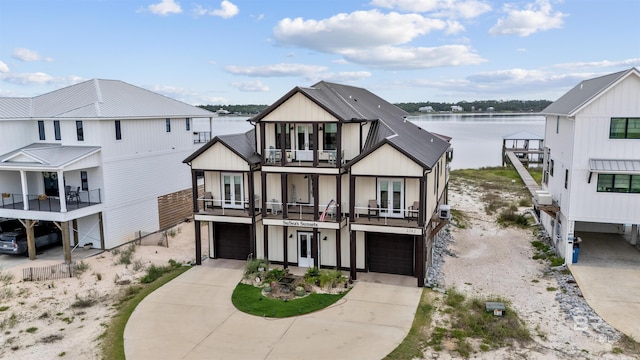2282 W W Beach Blvd, Gulf Shores, AL 36542 - view of front facade featuring a balcony, an attached garage, concrete driveway, and a water view