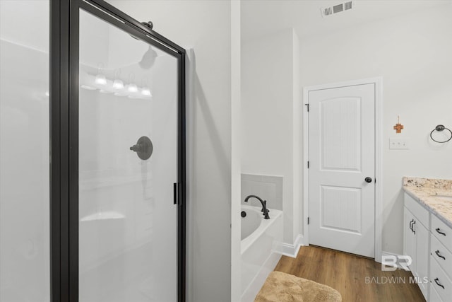 14437 Chenin Blanc Dr, Silverhill, AL 36576 - bathroom with a stall shower, vanity, wood finished floors, a bath, and baseboards