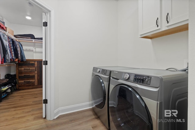 14437 Chenin Blanc Dr, Silverhill, AL 36576 - laundry room featuring cabinet space, light wood-style flooring, separate washer and dryer, and baseboards