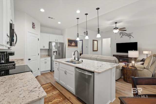 14437 Chenin Blanc Dr, Silverhill, AL 36576 - kitchen featuring stainless steel appliances, a sink, light wood finished floors, ceiling fan, and white cabinets