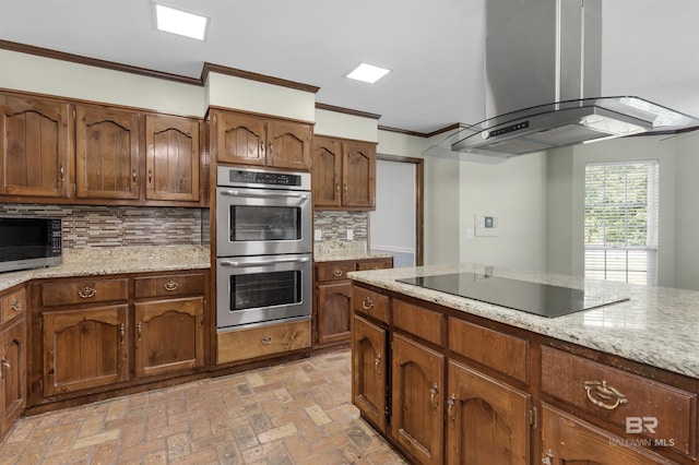9215 Shiloh Dr, Mobile, AL 36695 - kitchen featuring extractor fan, appliances with stainless steel finishes, crown molding, decorative backsplash, and brick flooring
