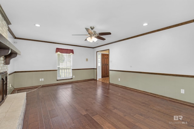 9215 Shiloh Dr, Mobile, AL 36695 - unfurnished living room featuring ceiling fan, a wainscoted wall, wood-type flooring, a fireplace, and crown molding