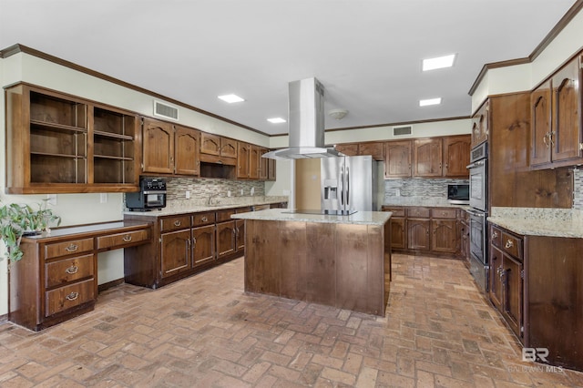 9215 Shiloh Dr, Mobile, AL 36695 - kitchen with crown molding, island exhaust hood, appliances with stainless steel finishes, open shelves, and backsplash