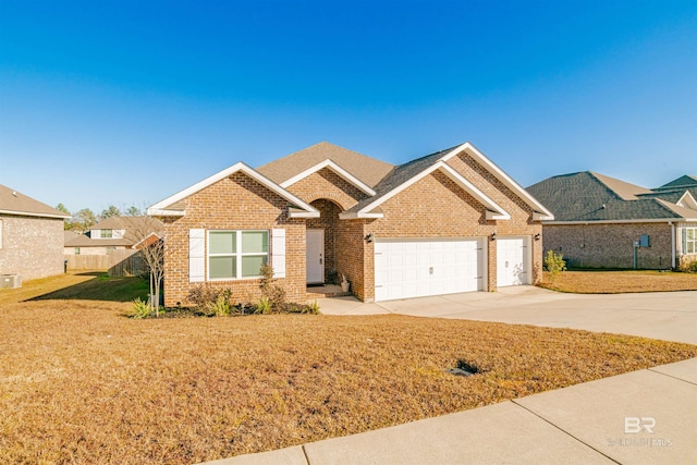 ranch-style home featuring an attached garage, a front yard, driveway, and brick siding