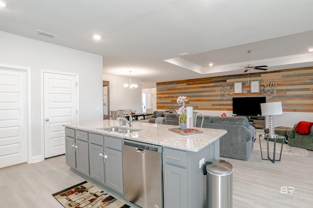 kitchen with visible vents, dishwasher, a sink, open floor plan, and light wood-style flooring